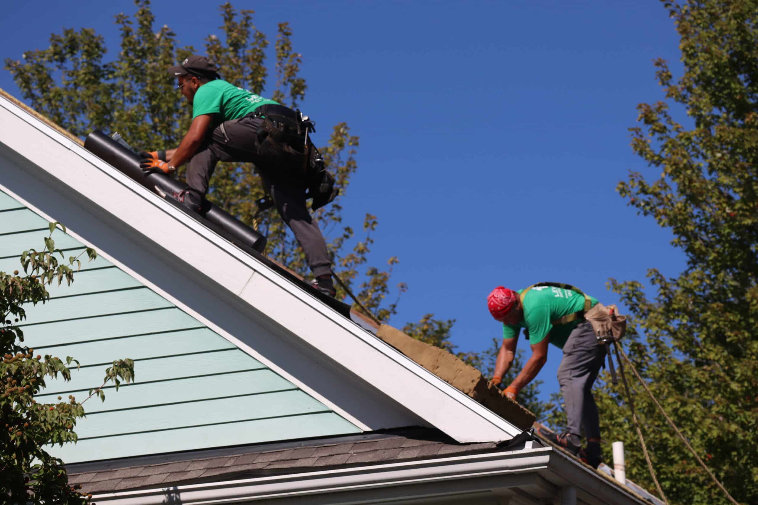 Roof Crew Tied Off On Steep Pitch Roof - Roof Safety