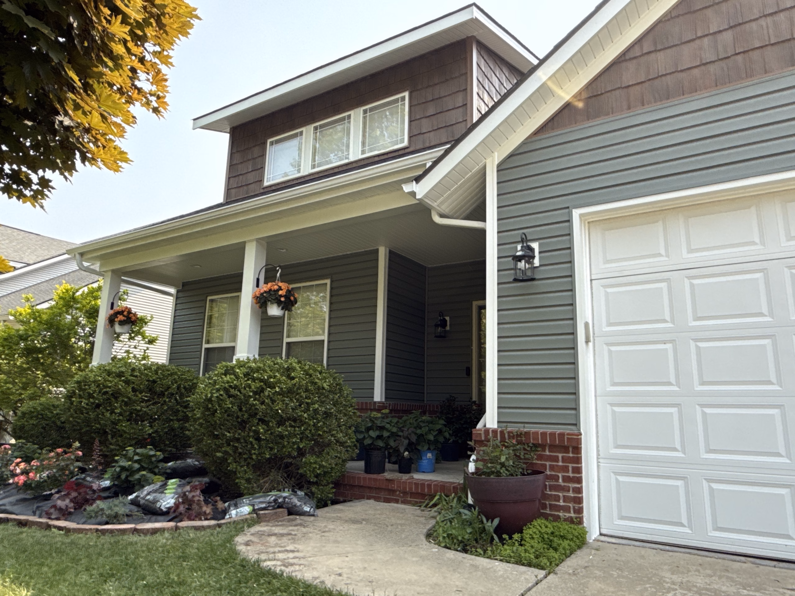 Completed vinyl siding installation by Level Up Improvement